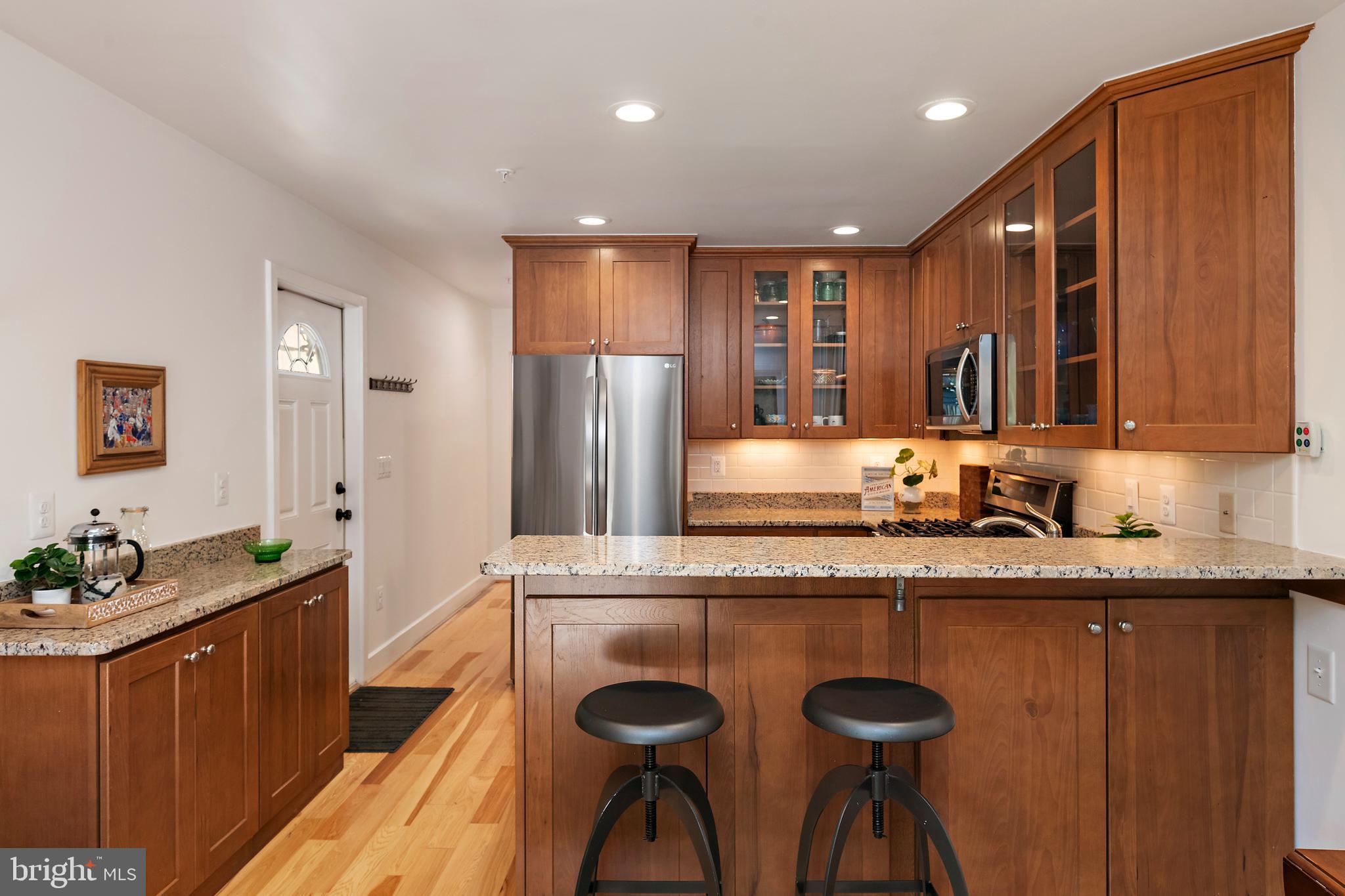 237 Hanover Street Annapolis, MD 21401 - Photo 28 of 48 a kitchen with granite countertop a sink and wooden cabinets