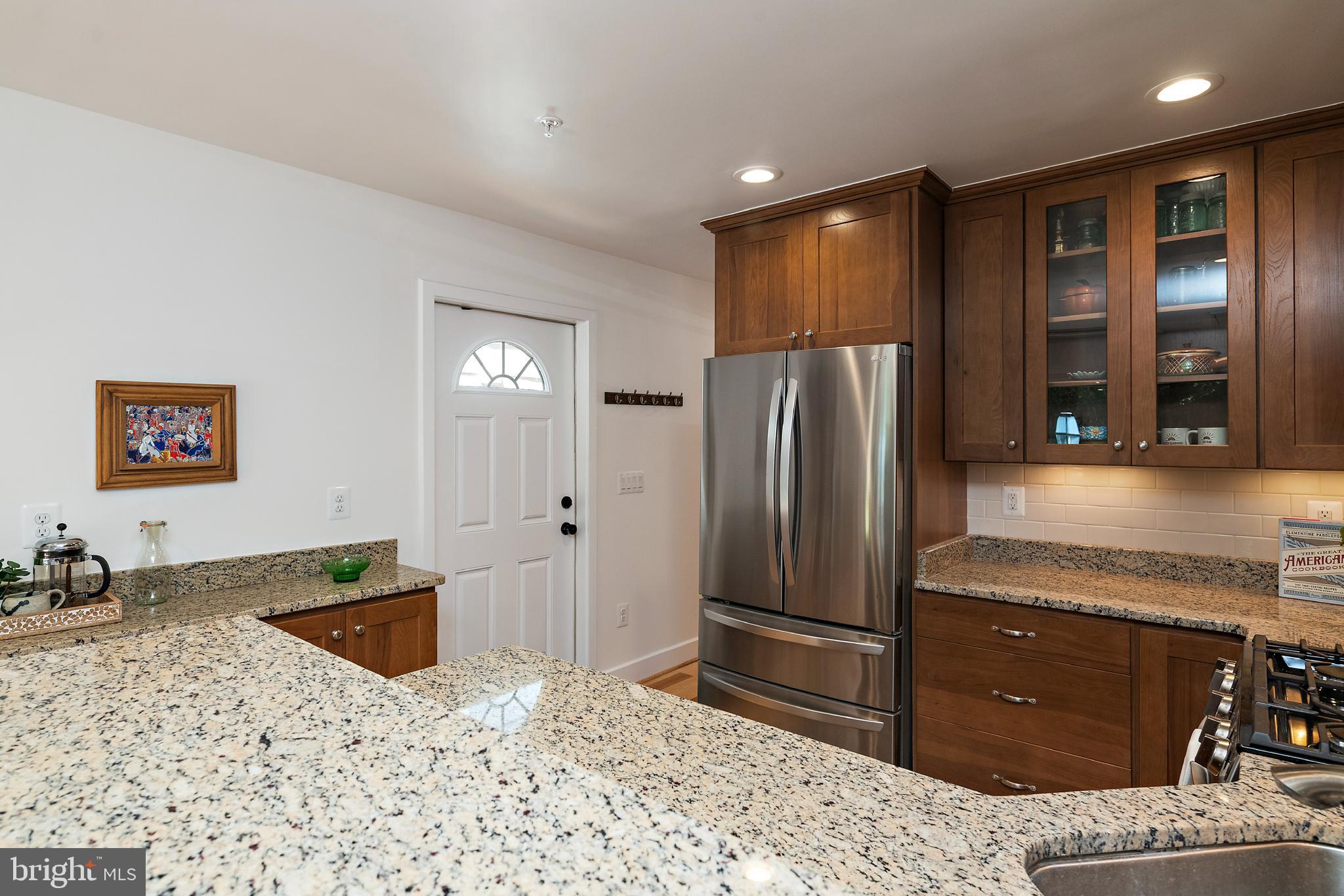 237 Hanover Street Annapolis, MD 21401 - Photo 29 of 48 a kitchen with stainless steel appliances kitchen island granite countertop a refrigerator and a sink