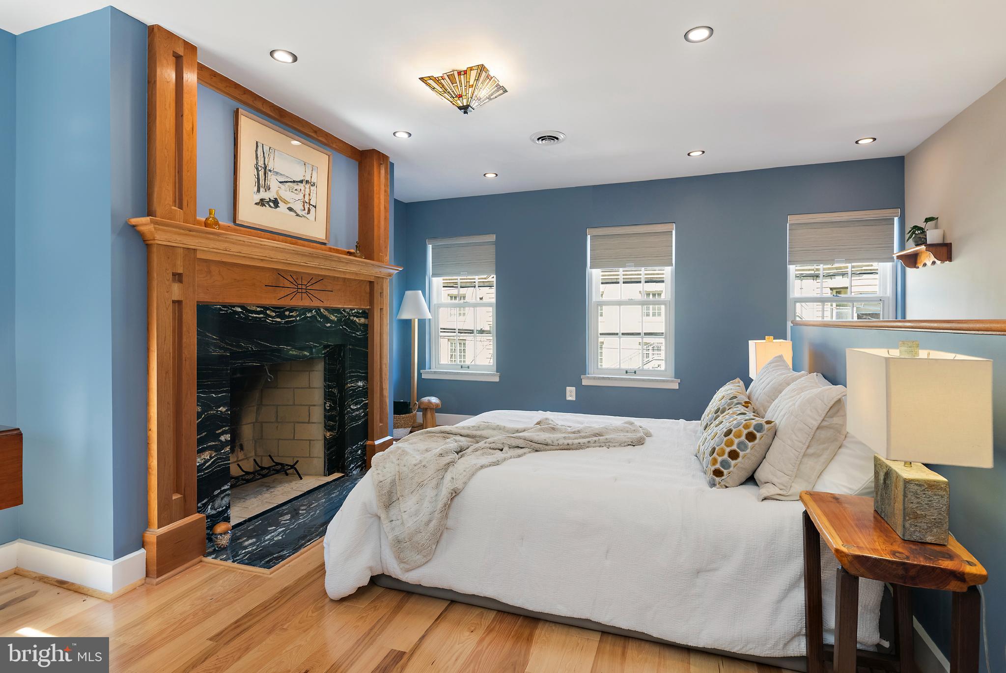 237 Hanover Street Annapolis, MD 21401 - Photo 34 of 48 a bedroom with a bed and a fireplace