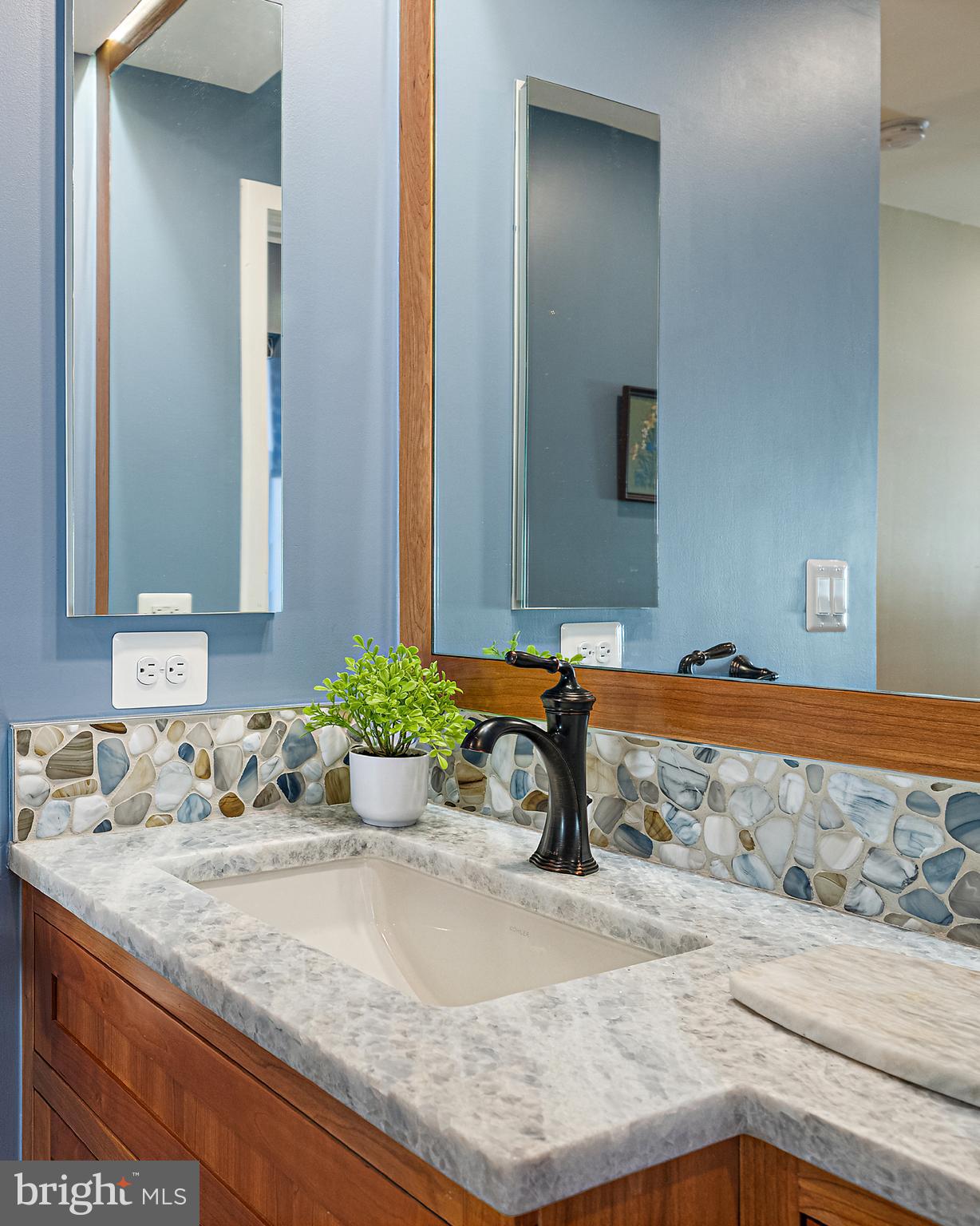 237 Hanover Street Annapolis, MD 21401 - Photo 40 of 48 a bathroom with a granite countertop sink and a mirror