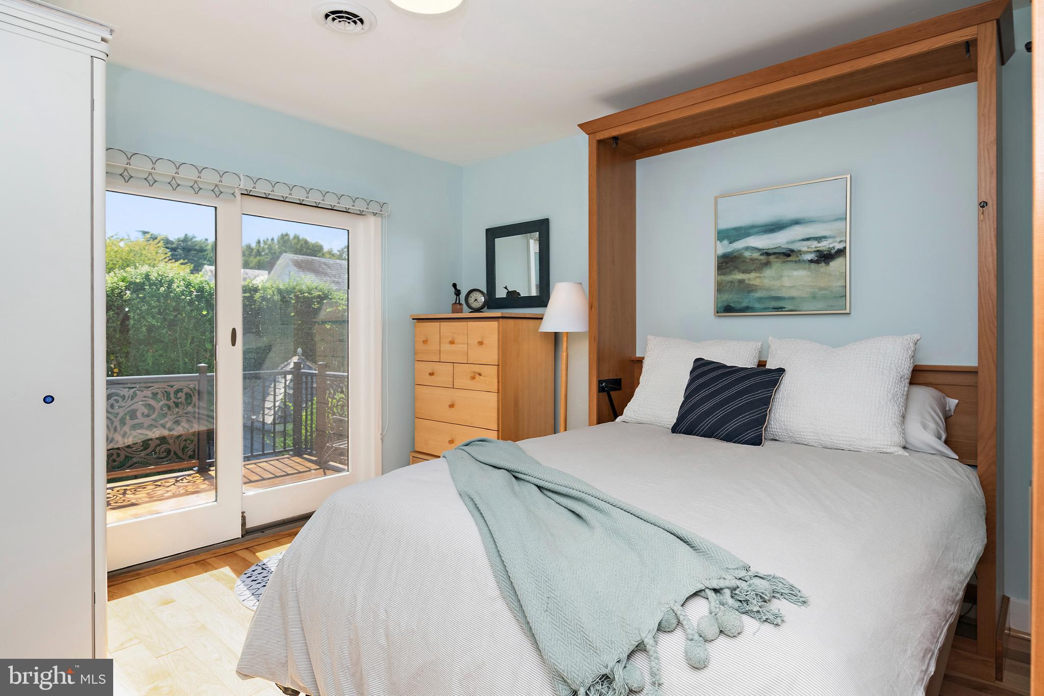 237 Hanover Street Annapolis, MD 21401 - Photo 42 of 48 a bedroom with a balcony a bed and a painting on the wall