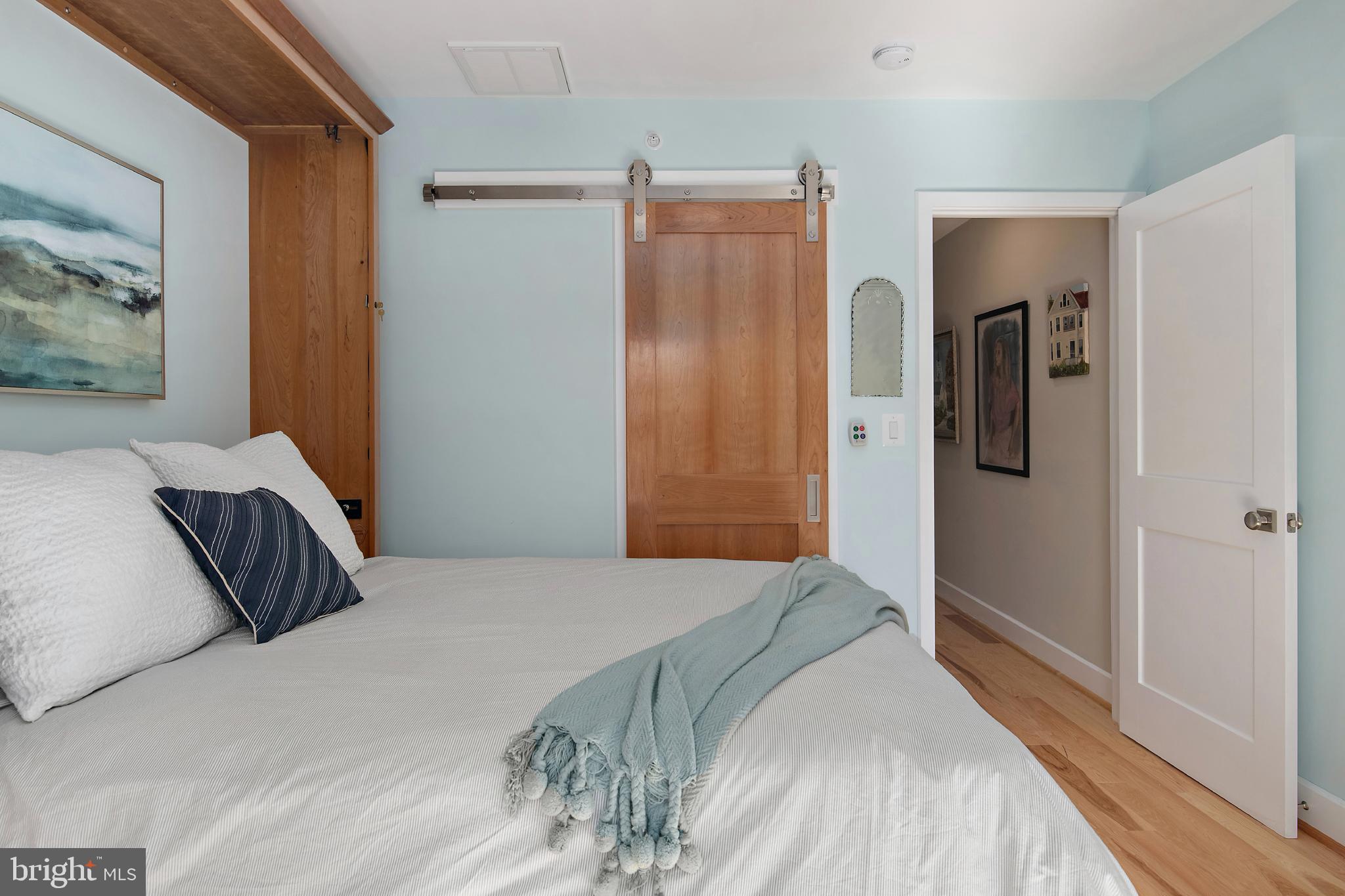 237 Hanover Street Annapolis, MD 21401 - Photo 43 of 48 a bedroom with a large bed and painting on the wall