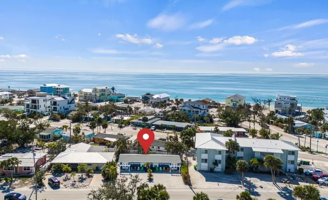 a group of people sitting in front of a house