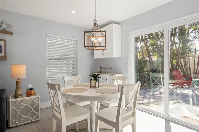 a living room with furniture a flat screen tv and kitchen view