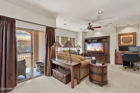 a bedroom with furniture and a large window