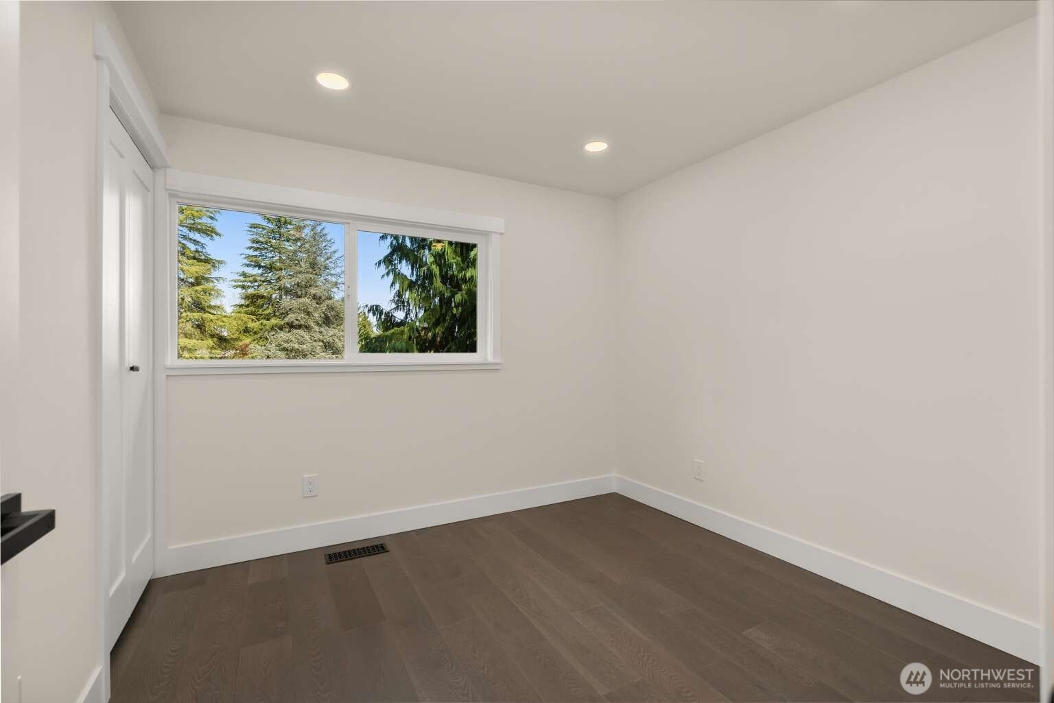 10811 Northeast 154th Court Bothell, WA 98011 - Photo 13 of 28 an empty room with wooden floor and window