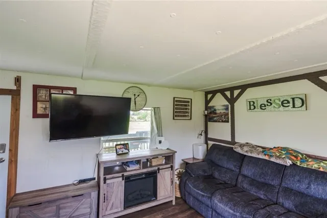 a bedroom with a bed next to a window and a chandelier