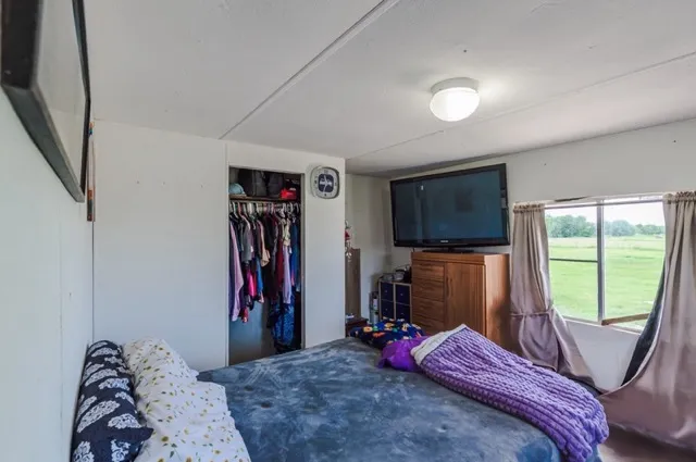 a view of a house with a yard and a large parking space