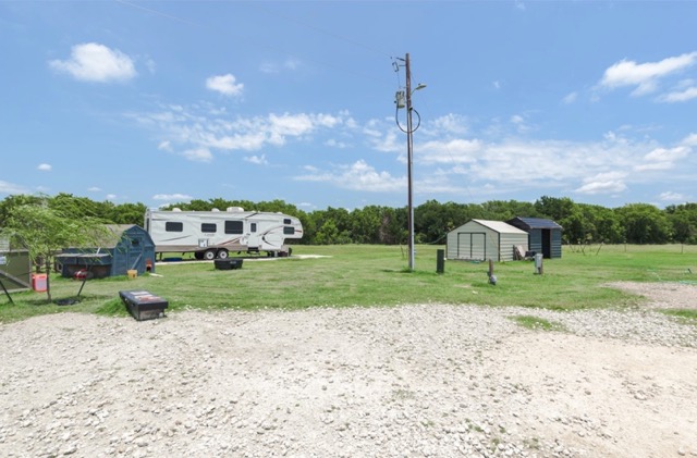 835 County Road 182 Marlin, TX 76661 - Photo 19 of 27 a view of a house with a big yard and a large tree