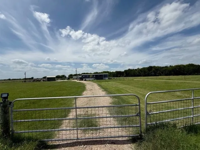 a kitchen with stainless steel appliances granite countertop a refrigerator a stove top oven a sink dishwasher and white cabinets with wooden floor