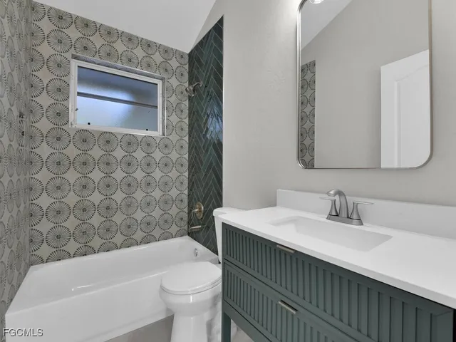 a bathroom with a sink a toilet and bathtub