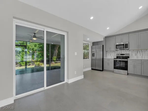 a view of a kitchen with refrigerator and a sink