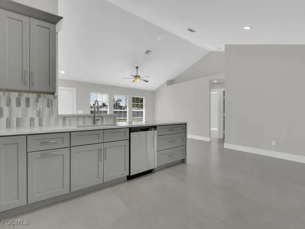 a kitchen with sink and cabinets