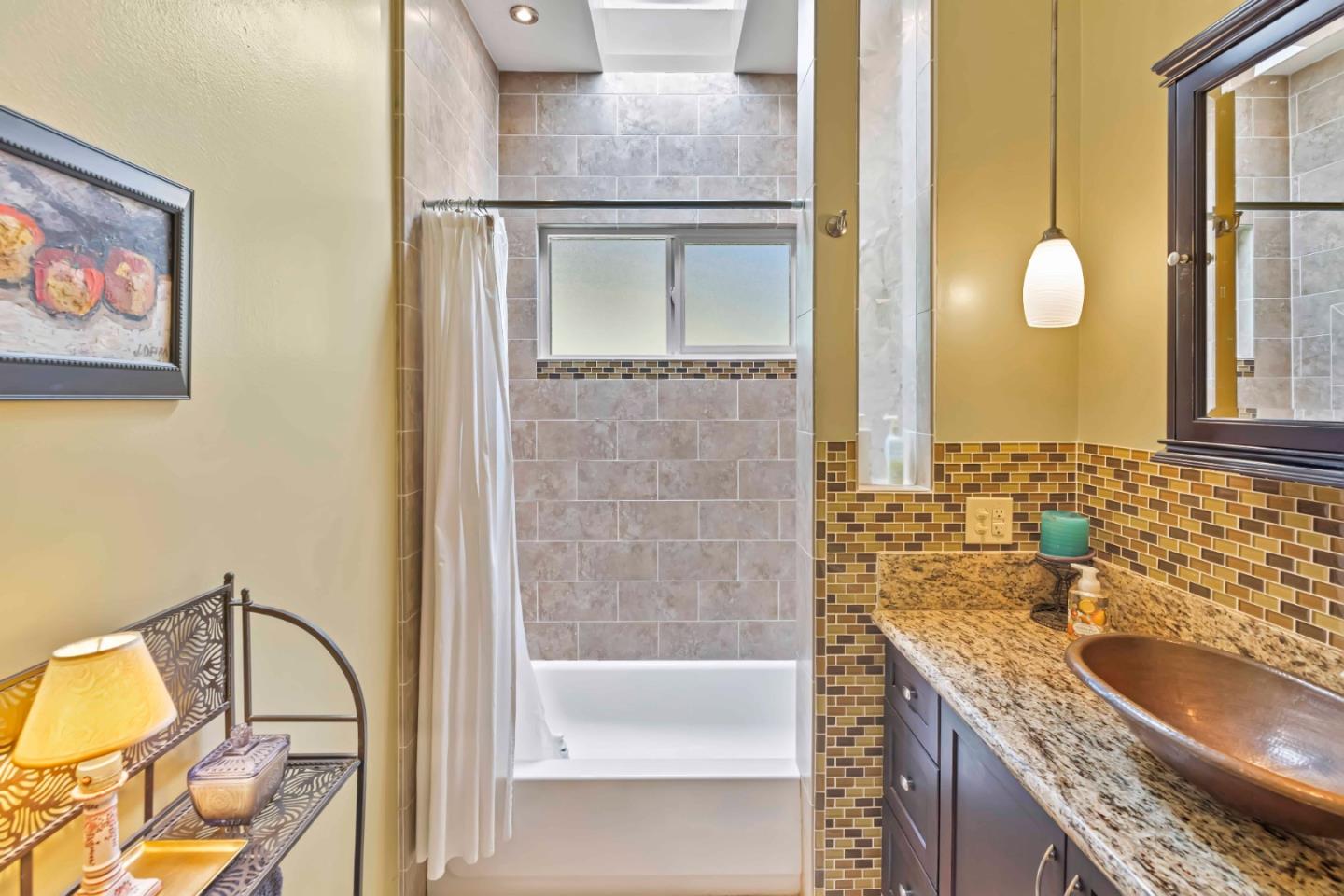 3405 Rio Road Carmel, CA 93923 - Photo 21 of 40 a bathroom with a granite countertop sink and a mirror