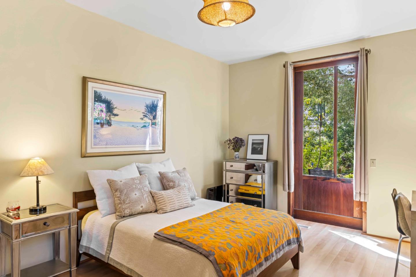 3405 Rio Road Carmel, CA 93923 - Photo 22 of 40 a bedroom with a bed and a painting on the wall