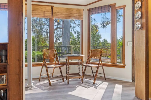 a glass door and chair sitting in front of a window
