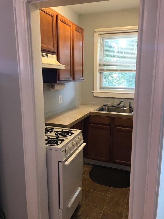 a kitchen with stainless steel appliances a stove and a microwave