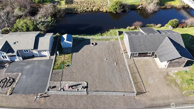 an aerial view of a house with a yard and seating space