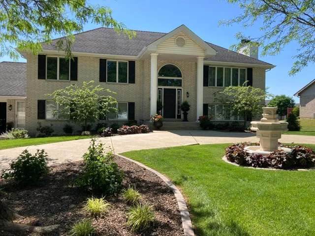a front view of a house with garden