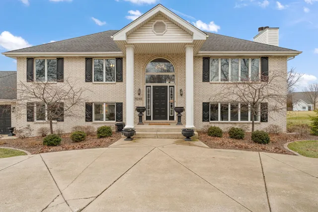 a view of a hallway with wooden floor and stairs