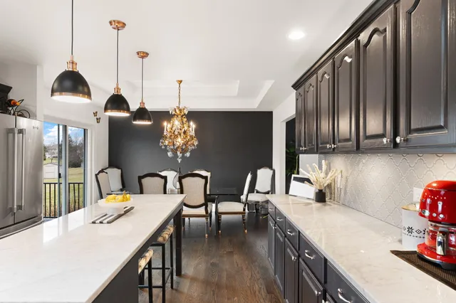 a kitchen with stainless steel appliances a sink stove and refrigerator