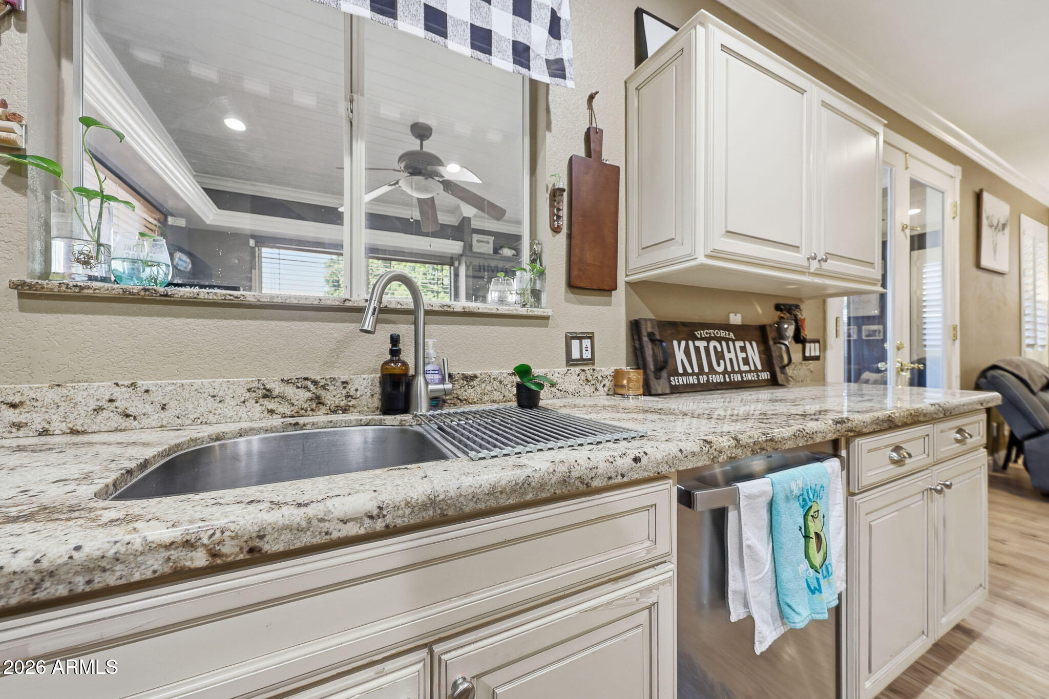 16248 West Hadley Street Goodyear, AZ 85338 - Photo 11 of 55 a kitchen with granite countertop a sink and a wooden floor