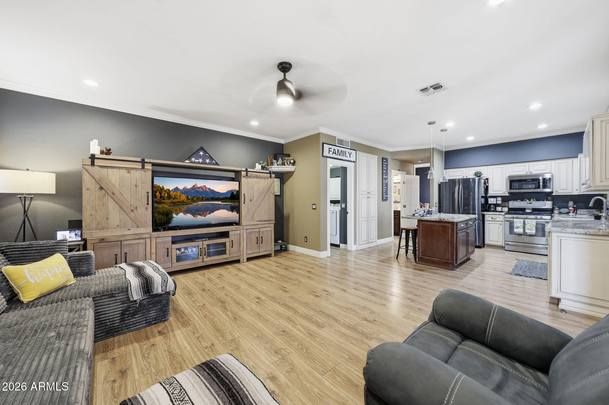 16248 West Hadley Street Goodyear, AZ 85338 - Photo 13 of 55 a living room with furniture and a flat screen tv