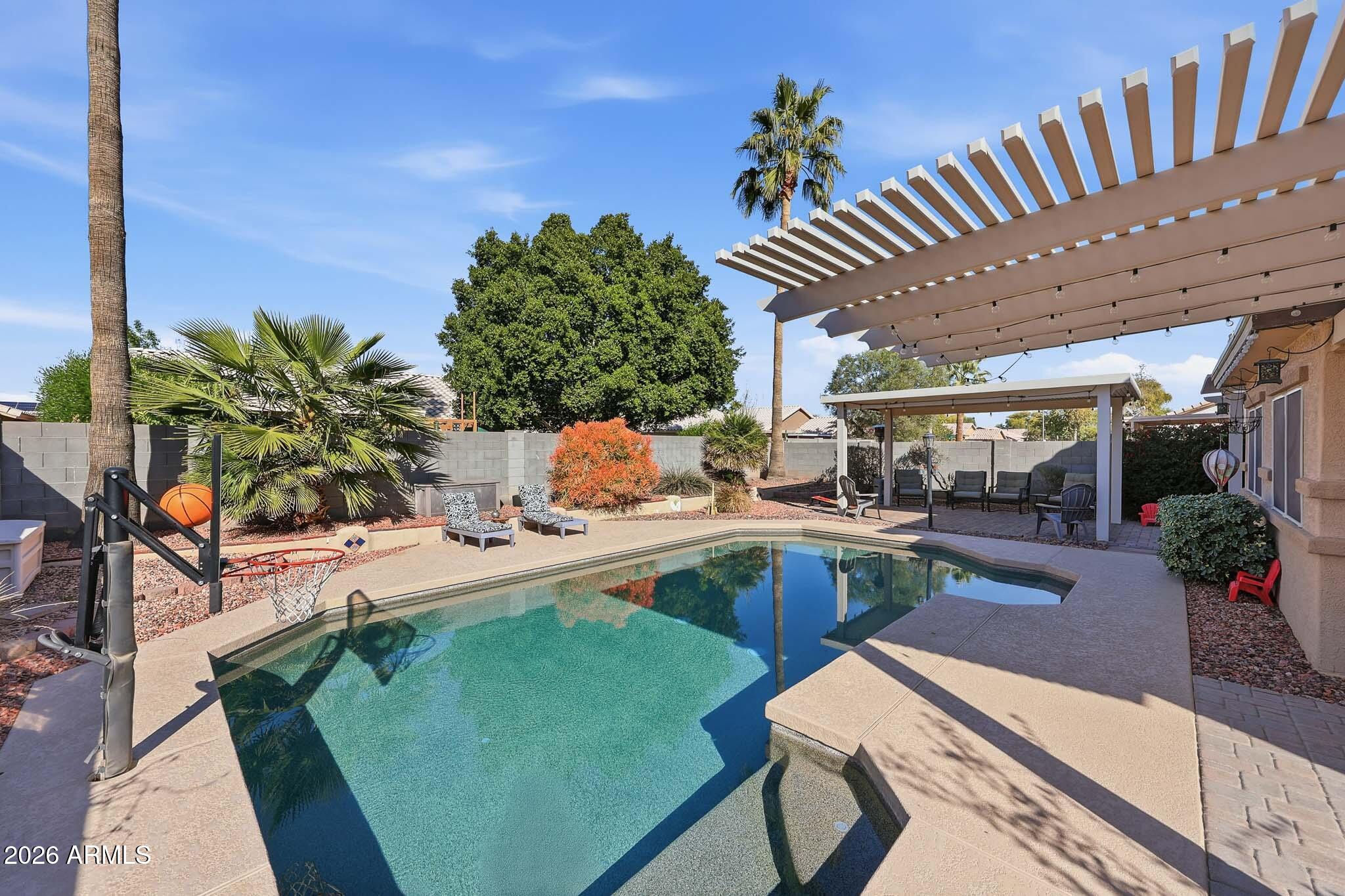 16248 West Hadley Street Goodyear, AZ 85338 - Photo 27 of 55 a view of a patio with table and chairs potted plants with wooden floor