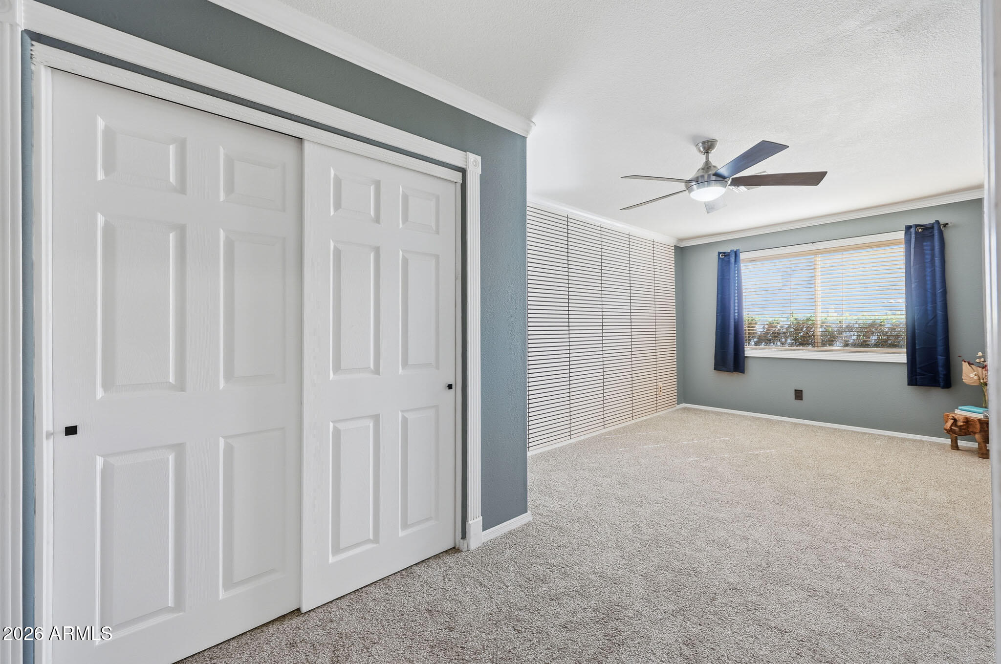 16248 West Hadley Street Goodyear, AZ 85338 - Photo 31 of 55 a big room with closet and a chandelier fan