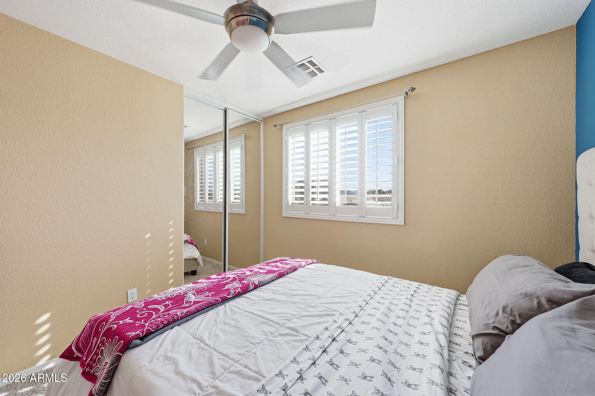 16248 West Hadley Street Goodyear, AZ 85338 - Photo 33 of 55 a bedroom with a bed and a window