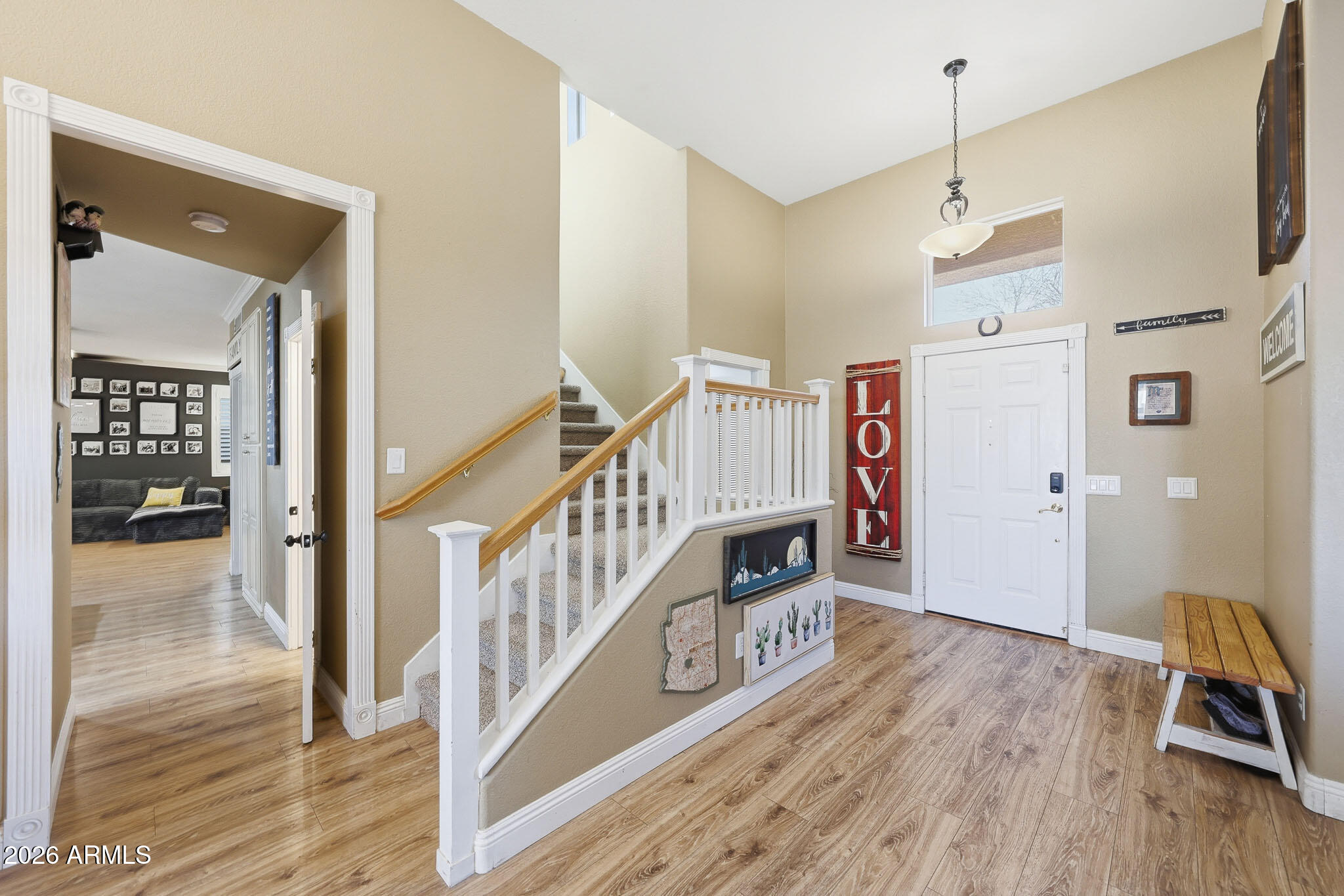16248 West Hadley Street Goodyear, AZ 85338 - Photo 3 of 55 a view of a hallway with wooden floor and staircase