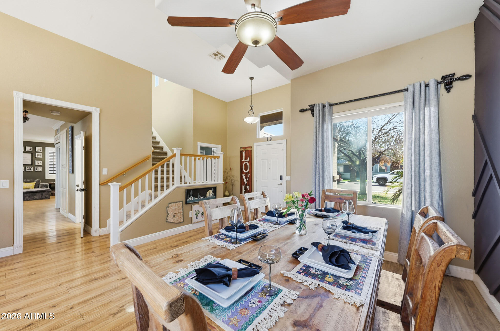 16248 West Hadley Street Goodyear, AZ 85338 - Photo 5 of 55 a view of a dining room with furniture window and wooden floor