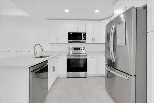 a kitchen with stainless steel appliances a refrigerator stove and microwave