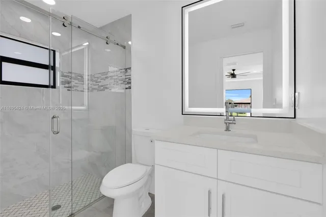 a bathroom with a toilet sink and a mirror