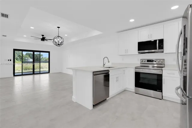a kitchen with stainless steel appliances a stove top oven and a sink