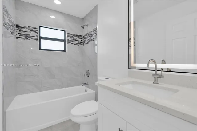 a bathroom with a sink a toilet and a bathtub