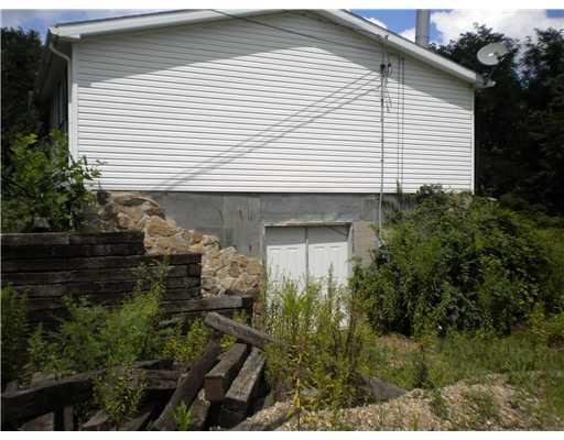 Exterior Front. Side view. Foundation with French Doors Gravel Driveway