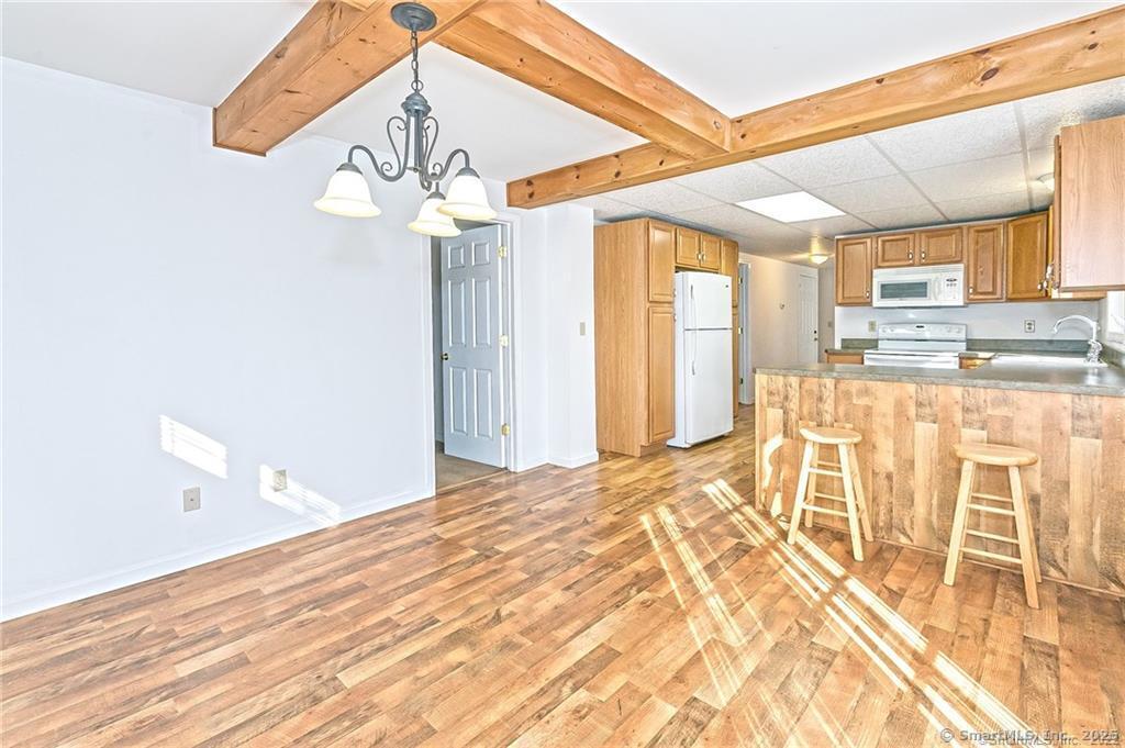 a bedroom with a bed dresser and a large window