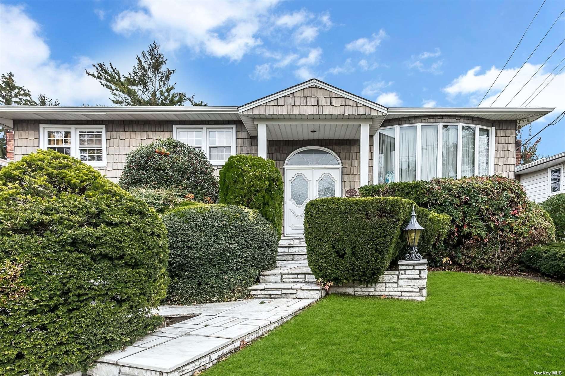 506 Hungry Harbor Road Valley Stream, NY 11581 - Photo 1 of 1 a front view of a house with garden