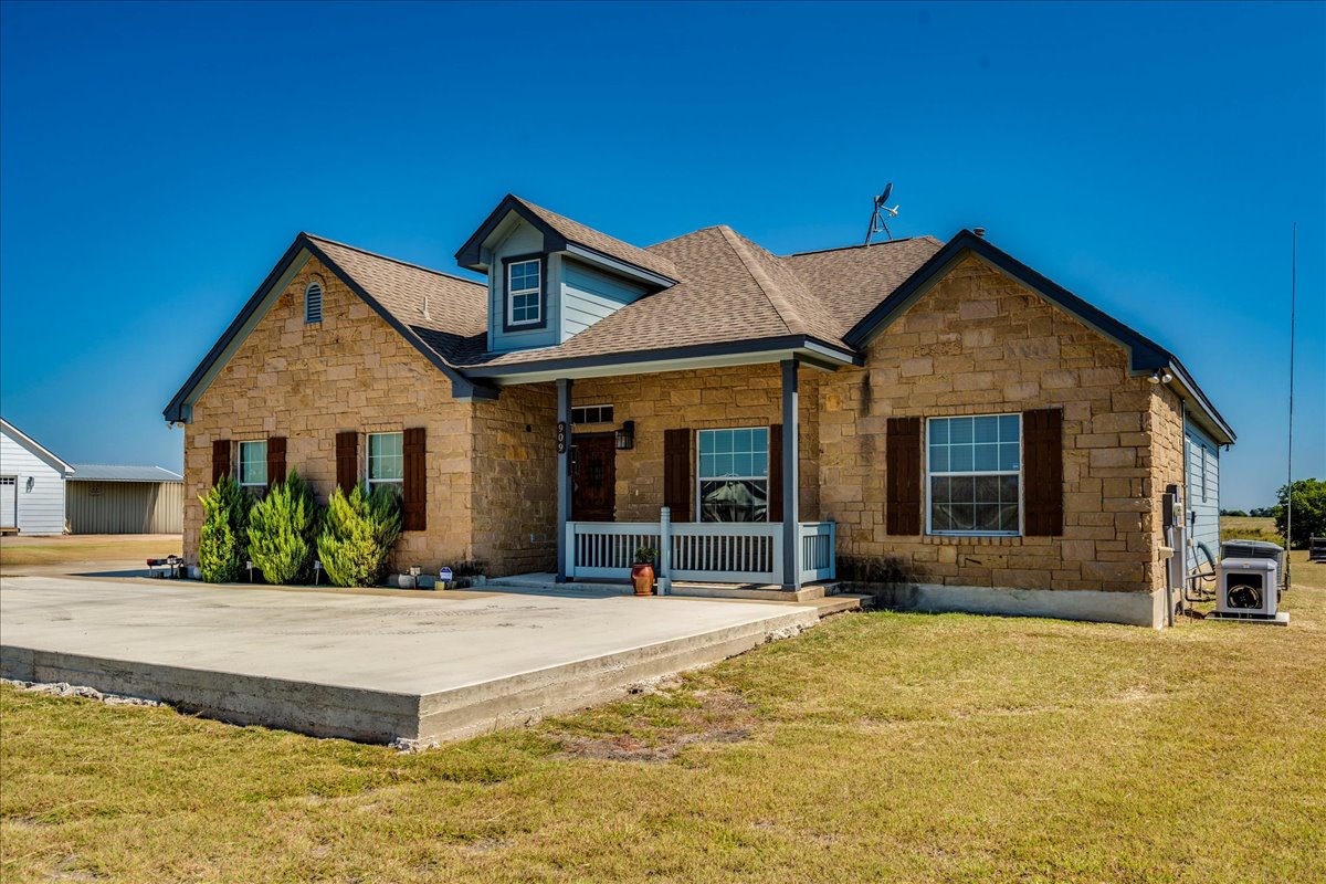 909 County Road 342 Granger, TX 76530 - Photo 7 of 37 View of front of property with stone siding, covered porch,