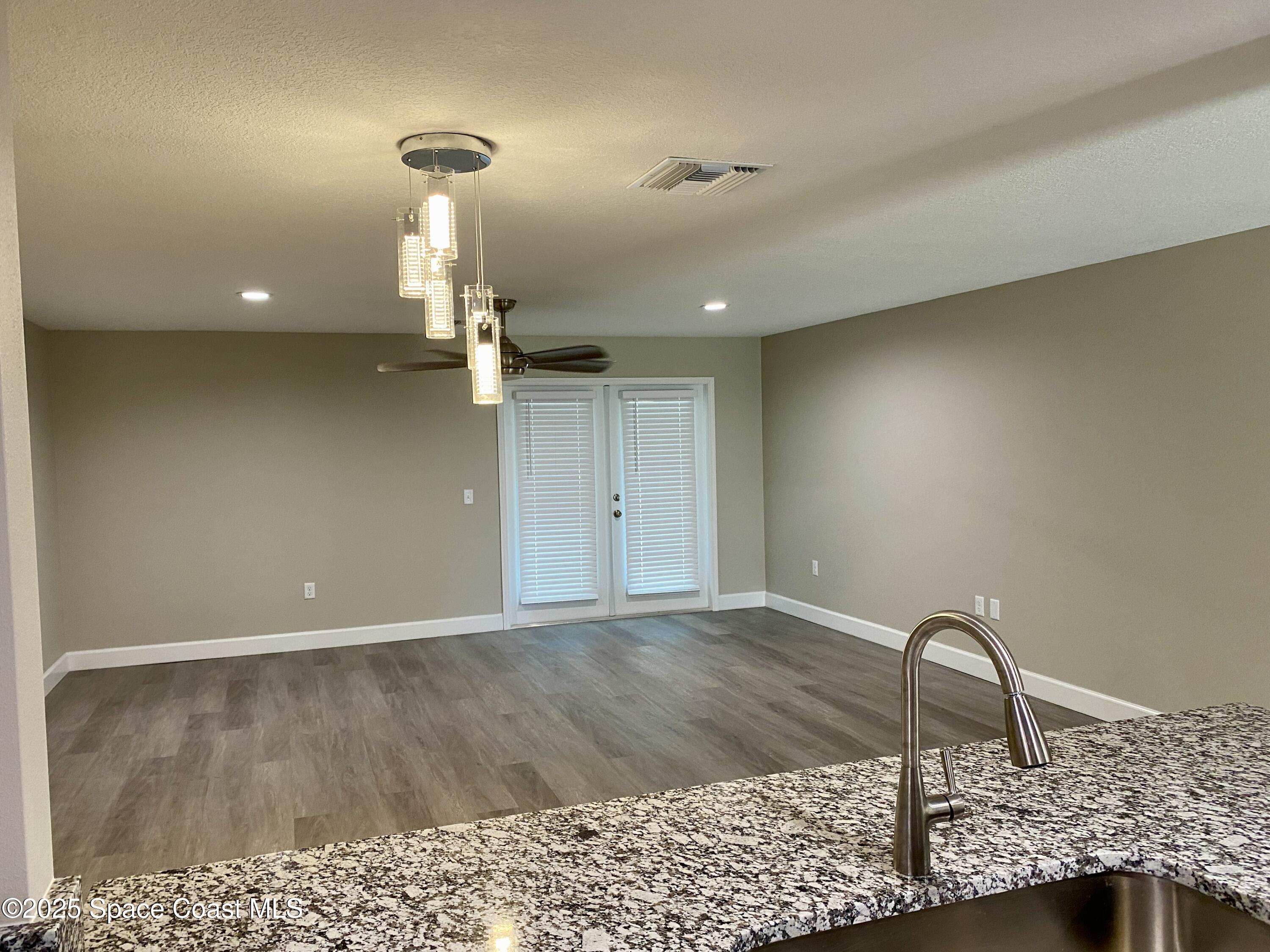 6005 Sisson Road Titusville, FL 32780 - Photo 4 of 16 a view of a room with a ceiling fan