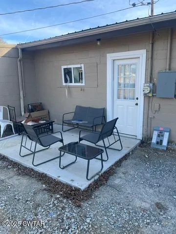 a backyard of a house with table and chairs