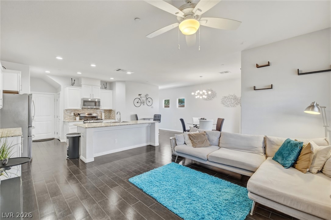 48 Jasmine Point Street Henderson, NV 89074 - Photo 19 of 62 An open-concept living area flows seamlessly into a well-appointed kitchen, perfect for entertaining.