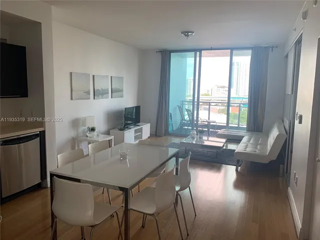 a view of a dining room with furniture and wooden floor