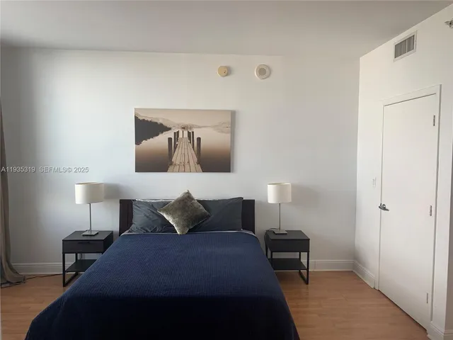 a bedroom with a bed and lamp