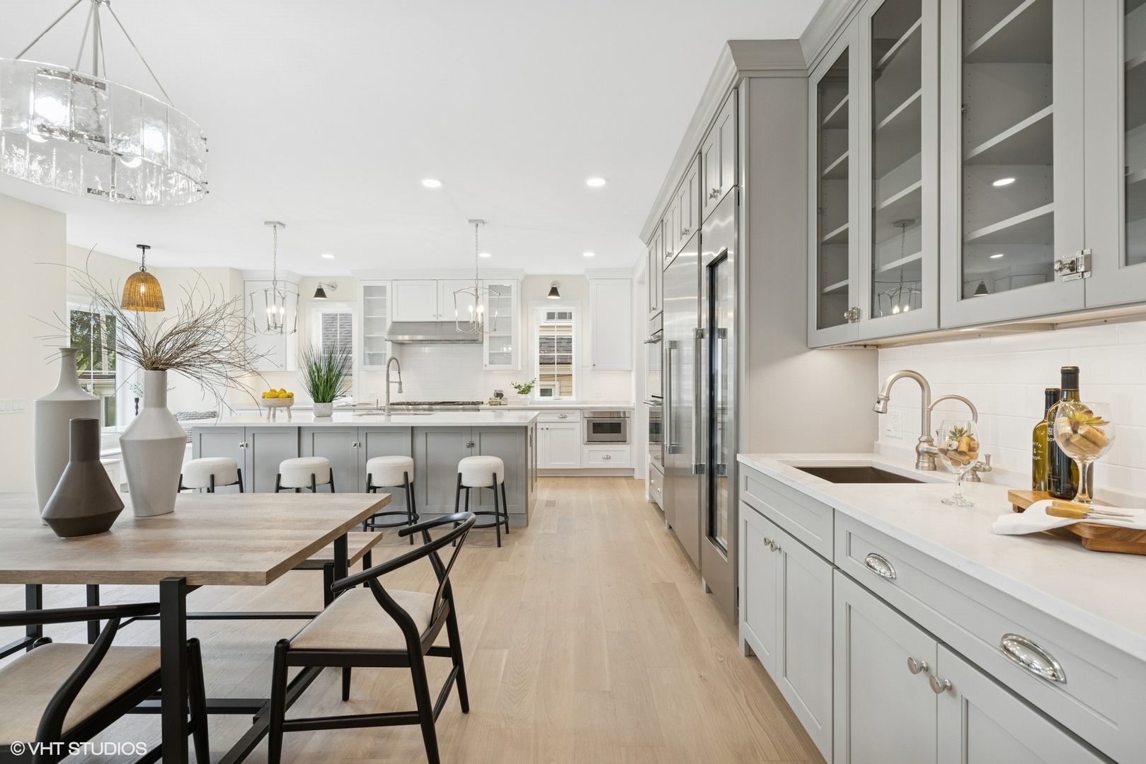 227 South Mitchell Avenue Arlington Heights, IL 60005 - Photo 7 of 40 a kitchen with stainless steel appliances kitchen island granite countertop a table chairs in it and wooden floors