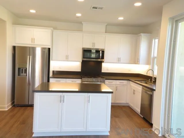 4382 Pacifica Way, Unit 5 Oceanside, CA 92056 - Photo 18 of 35 a kitchen with a refrigerator and a sink