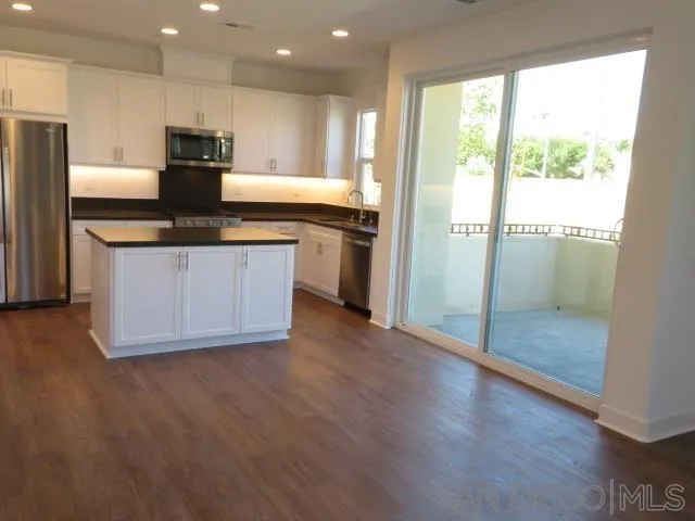4382 Pacifica Way, Unit 5 Oceanside, CA 92056 - Photo 19 of 35 a kitchen with a refrigerator and a sink