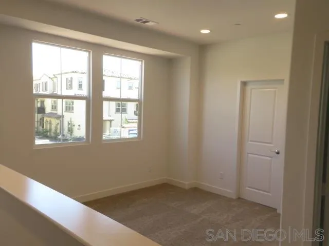 4382 Pacifica Way, Unit 5 Oceanside, CA 92056 - Photo 23 of 35 a view of an empty room with a window
