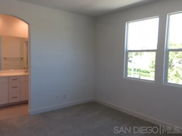 4382 Pacifica Way, Unit 5 Oceanside, CA 92056 - Photo 28 of 35 an empty room with a window